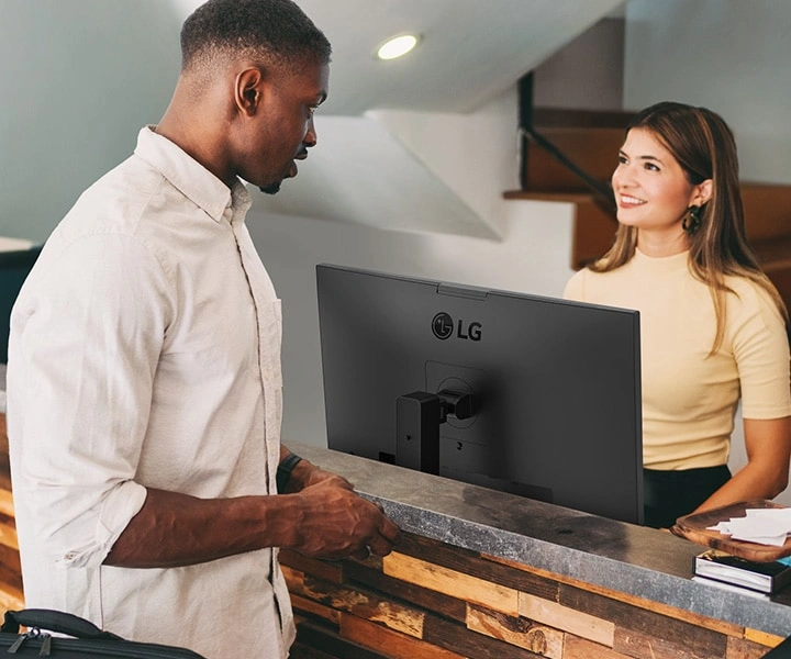 Downward height adjustment for customer communication at a reception desk